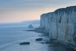 Cliffs with coastline at dawn, Etretat, Seine-Maritime Department, Atlantic Ocean, Normandy, France Cliffs with coastline at dawn, Etretat, Seine-Maritime Department, Atlantic Ocean, Normandy, France